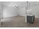 Open floor plan featuring tile flooring, a ceiling fan, and a kitchen island with pendant lighting at 17339 Elmwood Ave, Port Charlotte, FL 33948