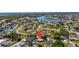 An aerial view of the property in a waterfront residential neighborhood with canals and a lake at 209 Seminole Nw Blvd, Port Charlotte, FL 33952