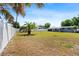 Spacious fenced backyard with tropical palm tree; ideal for outdoor entertaining and relaxation at 209 Seminole Nw Blvd, Port Charlotte, FL 33952