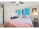 Comfortable bedroom with light blue curtains, a closet, and a vanity table at 209 Seminole Nw Blvd, Port Charlotte, FL 33952