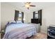 This bedroom features a ceiling fan, television, and two windows at 209 Seminole Nw Blvd, Port Charlotte, FL 33952