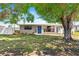 Charming single-story home with mature trees and well-maintained lawn at 209 Seminole Nw Blvd, Port Charlotte, FL 33952