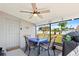 Relaxing lanai featuring a dining table, ceiling fan, and backyard views at 209 Seminole Nw Blvd, Port Charlotte, FL 33952