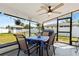 Relaxing lanai featuring a dining table, ceiling fan, and backyard views at 209 Seminole Nw Blvd, Port Charlotte, FL 33952