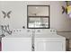 This laundry room features a washer and dryer, and window at 209 Seminole Nw Blvd, Port Charlotte, FL 33952