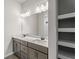 Bathroom featuring double sink vanity, modern finishes, and a large mirror at 21434 Dekals Ave, Port Charlotte, FL 33952