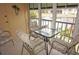 Relaxing screened-in lanai with seating area and views of the community waterway at 220 Coldeway Dr # 123, Punta Gorda, FL 33950
