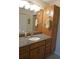 Bathroom with granite countertops, wooden cabinetry, and ample counter space at 220 Coldeway Dr # 123, Punta Gorda, FL 33950