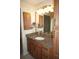 Bathroom featuring a granite countertop vanity with ample lighting and cabinet space at 220 Coldeway Dr # 123, Punta Gorda, FL 33950
