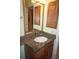 Bathroom featuring a granite countertop, vanity with storage, and a large mirror at 220 Coldeway Dr # 123, Punta Gorda, FL 33950
