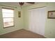 Light and airy bedroom featuring a neutral carpet, a large closet, and a window bringing in natural light at 220 Coldeway Dr # 123, Punta Gorda, FL 33950
