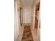 Bright condo hallway featuring tile floors, coat closet, and neutral decor, leading to the living spaces at 220 Coldeway Dr # 123, Punta Gorda, FL 33950