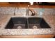 Kitchen sink features stainless steel fixtures, black basin, and tan granite countertop at 220 Coldeway Dr # 123, Punta Gorda, FL 33950