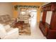 Bright living room featuring tile floors, neutral walls, comfortable sofas, and a sliding door to a balcony at 220 Coldeway Dr # 123, Punta Gorda, FL 33950