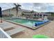 Inviting community pool with ample lounge seating and sun umbrellas, perfect for relaxation at 220 Coldeway Dr # 123, Punta Gorda, FL 33950