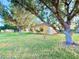 Spacious backyard featuring a lush lawn and mature trees, perfect for outdoor activities and relaxation at 22299 Catherine Ave, Port Charlotte, FL 33952