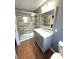 Bright bathroom featuring walk-in shower, tiled walls, and updated vanity at 22299 Catherine Ave, Port Charlotte, FL 33952