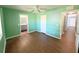 Bright bedroom with wood-look flooring, a ceiling fan, and a double door closet at 22299 Catherine Ave, Port Charlotte, FL 33952