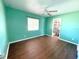 Green bedroom with a ceiling fan, window, and connected bathroom at 22299 Catherine Ave, Port Charlotte, FL 33952