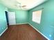 Bright bedroom with hard wood flooring, a ceiling fan, and natural light at 22299 Catherine Ave, Port Charlotte, FL 33952