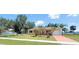 Charming single-story home featuring a lush front yard and a long driveway, under a clear sky at 22299 Catherine Ave, Port Charlotte, FL 33952