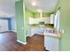 Clean kitchen with white cabinets and matching appliances next to living area at 22299 Catherine Ave, Port Charlotte, FL 33952