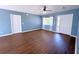 Open living room boasts hardwood floors, natural light, and neutral paint, creating a warm and inviting space at 22299 Catherine Ave, Port Charlotte, FL 33952