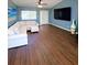 Inviting living room with wood floors, ceiling fan, and cozy seating arrangement at 22299 Catherine Ave, Port Charlotte, FL 33952