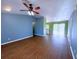 Spacious living room with wood flooring and views into a kitchen area at 22299 Catherine Ave, Port Charlotte, FL 33952