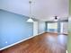 Bright living space with hard wood floors, fresh paint, and a ceiling fan at 22299 Catherine Ave, Port Charlotte, FL 33952