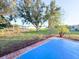 Spacious patio overlooks a landscaped backyard with mature trees at 22299 Catherine Ave, Port Charlotte, FL 33952