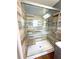Walk-in shower featuring horizontal tiling, multiple grab bars, and a seat at 22299 Catherine Ave, Port Charlotte, FL 33952