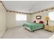 Bright bedroom with cream walls, a green bedspread, and a border of floral wallpaper at 22385 Olean Blvd, Port Charlotte, FL 33952