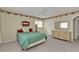 Bedroom featuring green bedspread, carpet, and overhead fan at 22385 Olean Blvd, Port Charlotte, FL 33952