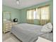 Cozy bedroom featuring a vintage-style dresser and a window with floral patterned curtains at 22385 Olean Blvd, Port Charlotte, FL 33952