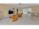 Spacious living room with tile floors, ceiling fan, and sliding glass doors to the lanai at 22385 Olean Blvd, Port Charlotte, FL 33952