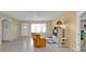 Bright living room with large window, neutral tile flooring, ceiling fan, and an open entry, ideal for relaxation and entertaining at 22385 Olean Blvd, Port Charlotte, FL 33952