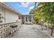Back patio complete with mature tropical landscaping and a grill, perfect for outdoor entertaining at 22385 Olean Blvd, Port Charlotte, FL 33952
