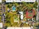 Community aerial view featuring the pool, shuffleboard, tennis courts, and community center at 2290 Aaron St # 312, Port Charlotte, FL 33952