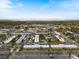 Aerial view of property in a community with a parking lot, tennis courts and pool at 2290 Aaron St # 312, Port Charlotte, FL 33952