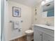 Bright bathroom featuring a vanity with storage, a white toilet, and a framed floral art piece at 2290 Aaron St # 312, Port Charlotte, FL 33952