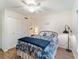 Bedroom with a patterned comforter on the bed, a ceiling fan, and a closet with sliding doors at 2290 Aaron St # 312, Port Charlotte, FL 33952
