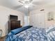 Cozy bedroom featuring a ceiling fan, closet, dresser with TV, and floral bedspread at 2290 Aaron St # 312, Port Charlotte, FL 33952