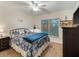 Bedroom features a patterned comforter, a window with blinds, and matching bedside tables at 2290 Aaron St # 312, Port Charlotte, FL 33952