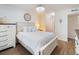Bright bedroom showcasing a white bed with white linens, stylish lighting, and access to a closet at 2290 Aaron St # 312, Port Charlotte, FL 33952