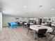 Large community room with lots of table seating, tile floors, and ceiling fans at 2290 Aaron St # 312, Port Charlotte, FL 33952