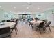 Large community room with lots of table seating, tile floors, and ceiling fans at 2290 Aaron St # 312, Port Charlotte, FL 33952