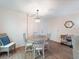 Dining area with wood floors, wicker chair, and hanging light fixture at 2290 Aaron St # 312, Port Charlotte, FL 33952