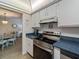 Kitchen view showcases stainless steel oven and cooktop plus coffee maker adjacent to a dining area at 2290 Aaron St # 312, Port Charlotte, FL 33952