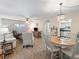 Bright living room with wood floors, ceiling fan, and chandelier-style pendant lighting at 2290 Aaron St # 312, Port Charlotte, FL 33952
